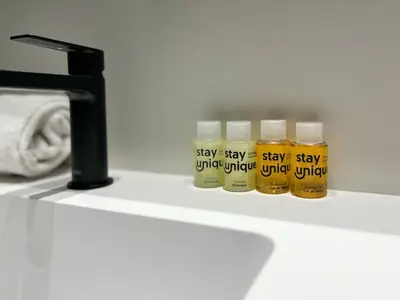 a row of cough syrup bottles on a shelf next to a sink at Stay U-nique Apartment Castanyer in Barcelona