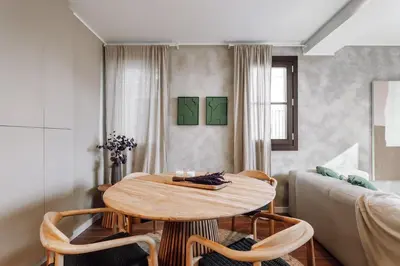 a living room with a table and a couch at Casa Ciudadela in Barcelona
