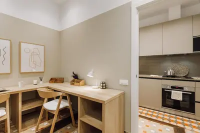 a kitchen with a wooden desk in a room at Casa Comtal in Barcelona