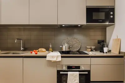 a kitchen with a sink and a stove top oven at Casa Comtal in Barcelona