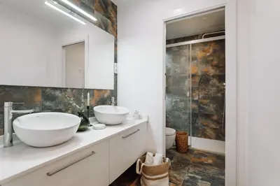 a bathroom with two sinks and a shower at Casa Narciso in Barcelona