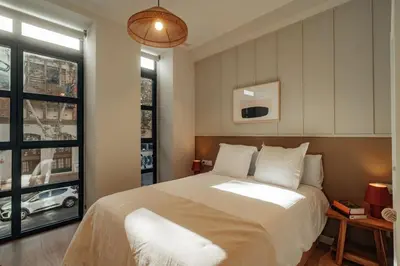 a bedroom with a large bed and a window at Casa Duran in Barcelona