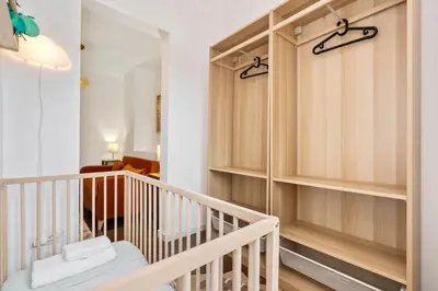 a staircase with wooden shelves in a room at Enrique Granados Apartment in Barcelona