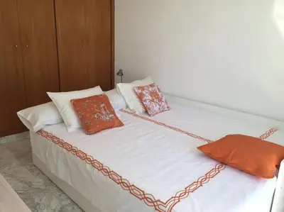 a white bed with pillows and a chain on it at House Seaviews Barcelona 22Km in Cabrils