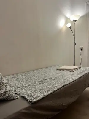 a bed in a room with a lamp on it at Triumf in Barcelona
