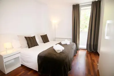 a bedroom with a bed with two towels on it at Glasir Homes Barcelona in Barcelona