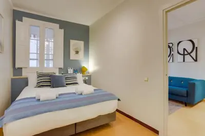 a bedroom with a large bed and a mirror at Sant Joan entresol in Barcelona