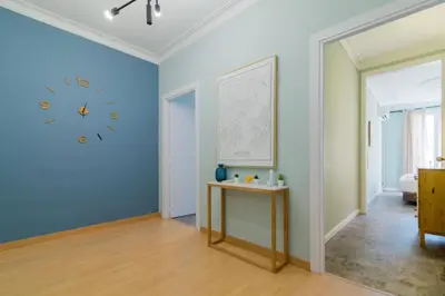 a room with a clock on a blue wall at Sant Joan entresol in Barcelona