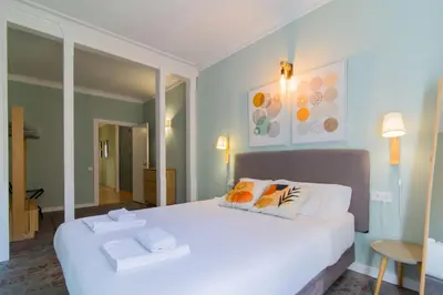 a bedroom with a large white bed with two pillows at Sant Joan entresol in Barcelona