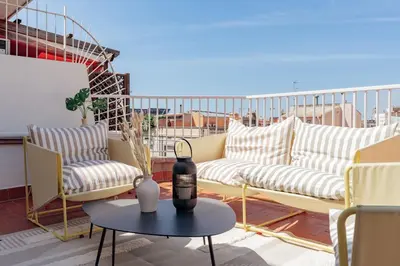 a balcony with couches and a table on a roof at Casa Gavina in Barcelona