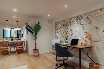 an office with a desk and a table with a laptop at Casa Goya in Barcelona