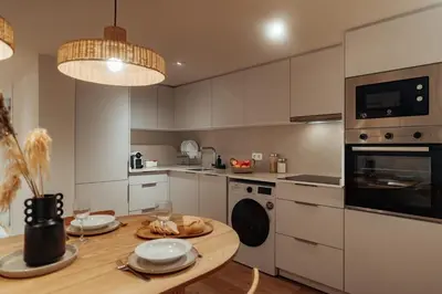 a kitchen with a wooden table and a dining room at Casa Goya in Barcelona