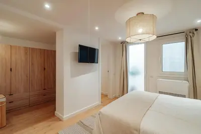 a bedroom with a bed and a tv on a wall at Casa Goya in Barcelona