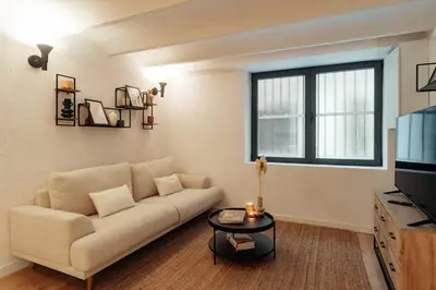 a living room with a couch and a tv at Casa Goya in Barcelona