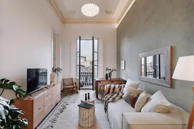 a living room with a couch and a tv at Casa Jordi in Barcelona