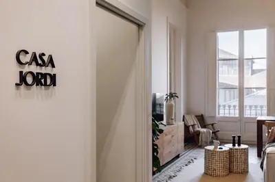 a living room with a door leading to a living room with a window at Casa Jordi in Barcelona