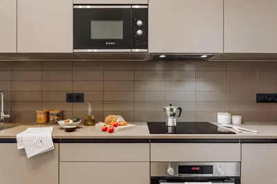 a kitchen with a counter top with a microwave at Casa Jordi in Barcelona