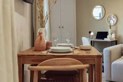 a wooden table with plates and wine glasses on it at Casa Laietana in Barcelona