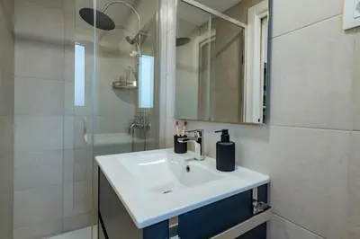 a bathroom with a white sink and a mirror at Casa Laietana in Barcelona