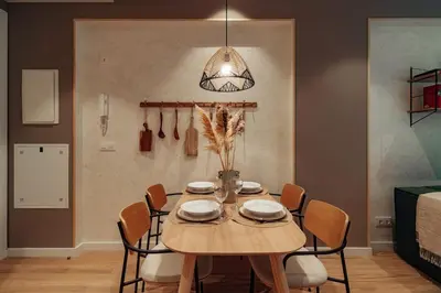 a dining room with a wooden table and chairs at Casa Macaya in Barcelona