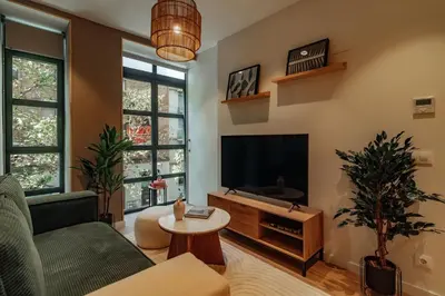a living room with a couch and a tv at Casa Macaya in Barcelona
