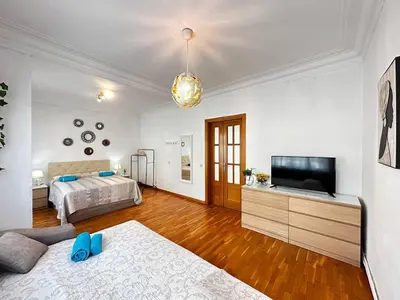 a bedroom with a bed and a flat screen tv at Habitaciones acogedoras en Aragón in Barcelona
