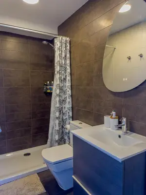 a bathroom with a sink and a toilet and a tub at Apartamento en la playa in Castelldefels