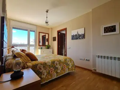a bedroom with a bed and a window at Pis molt cèntric amb vistes in Terrassa