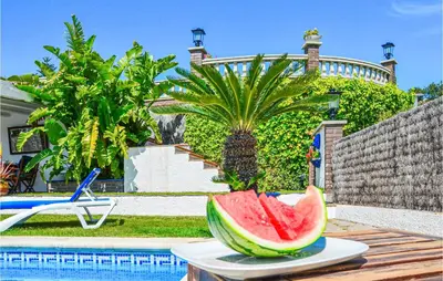 a bowl of watermelon on a table next to a pool at Lovely Home In St Cebrià De Vallalta in Sant Cebrià de Vallalta