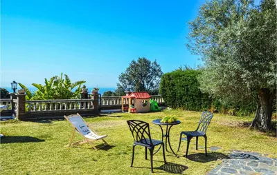 three chairs and a table in a yard at Lovely Home In St Cebrià De Vallalta in Sant Cebrià de Vallalta