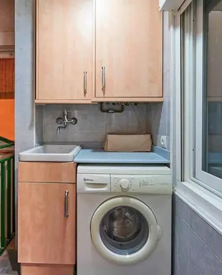 a washing machine in a kitchen with a sink at Canela Homes BARCELONA TETUAN in Barcelona