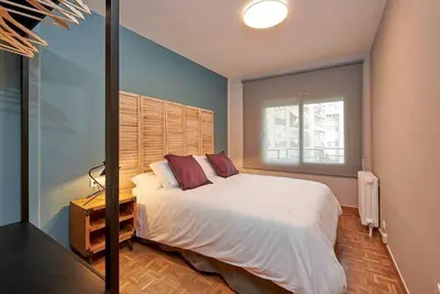 a bedroom with a white bed and a window at Canela Homes BARCELONA TETUAN in Barcelona
