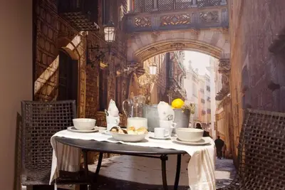 a table with cups and saucers on top of it at Canela Homes BARCELONA CENTRAL in Barcelona