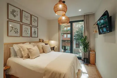 a bedroom with a bed and a tv and a window at Casa Marina in Barcelona