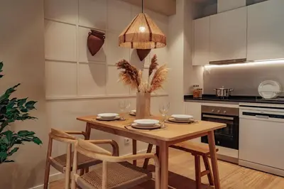 a kitchen with a wooden table and chairs at Casa Marina in Barcelona