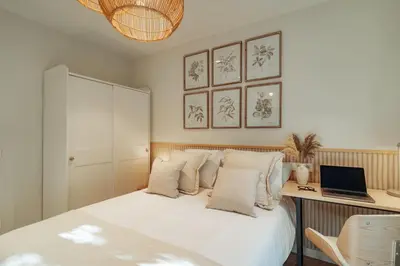 a bedroom with a bed with a desk and a laptop at Casa Marina in Barcelona