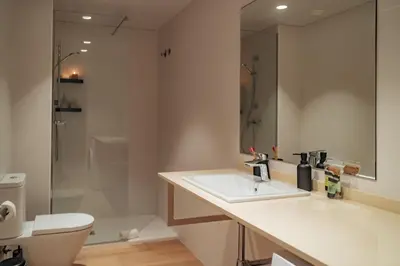 a bathroom with a sink and a toilet and a shower at Casa Seda in Barcelona