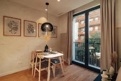 a dining room with a table and a window at Casa Seda in Barcelona