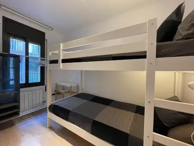 a bedroom with two bunk beds and a window at 15 min en metro a Sagrada Familia in Sant Adria de Besos