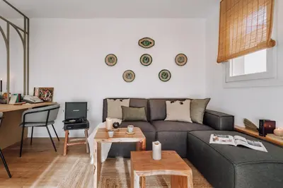 a living room with a couch and a tv at Olivo - 1 bedroom and terrace in Eixample Esquerra in Barcelona