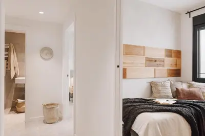 a wooden table with a bowl of fruit and candles at Ferrat - 3 bedrooms in Eixample Esquerra in Barcelona