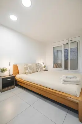 a bedroom with a large bed and a window at Chic Poble Nou Loft Terrace & Close to The Beach in Barcelona