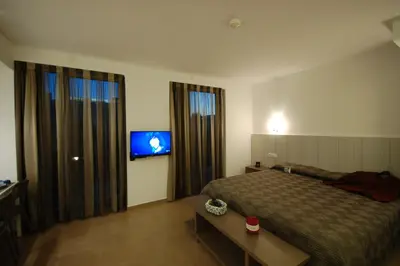 a hotel room with a bed and a television at Resort Sitges Apartment in Sitges