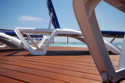 a deck with a chair and a table on a boat at Resort Sitges Apartment in Sitges
