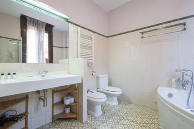 a bathroom with a sink and a toilet and a tub at Hotel Llar de Capitans in Masnou