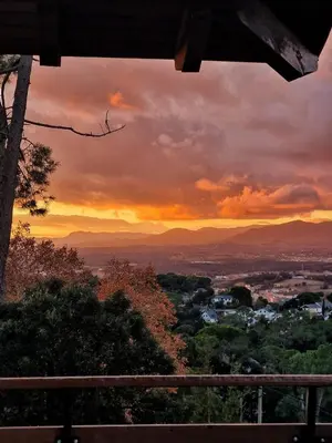 a sunset view of a city from a hill at L'AMAGATALL DEL MONTNEGRE in Villalba Saserra