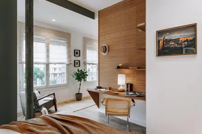 a living room with a couch and a potted plant at Niebla - 1 bedroom in Eixample Esquerra in Barcelona