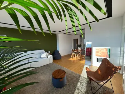 a living room with a white couch and a green wall at Paseo de Gracia Residences in Barcelona