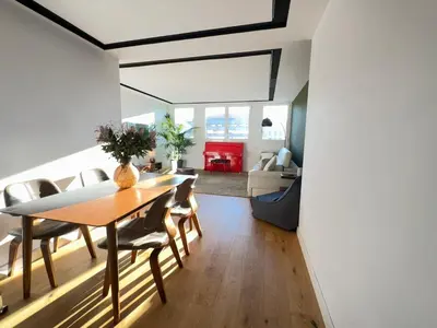 a dining room and living room with a table and chairs at Paseo de Gracia Residences in Barcelona