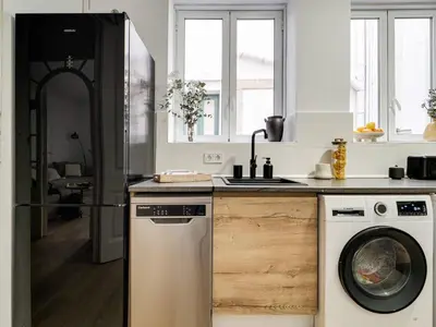 a kitchen with a dishwasher and a washer at Casa modernista en Paseo de Gracia in Barcelona
